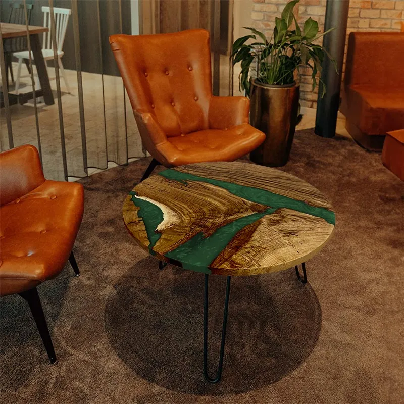Couchtisch rund aus Nussbaum mit Epoxidharz smaragd-grün | Modell Hegauvulkan